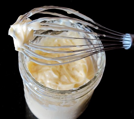 Creamy homemade mayonnaise dressing in a small bowl